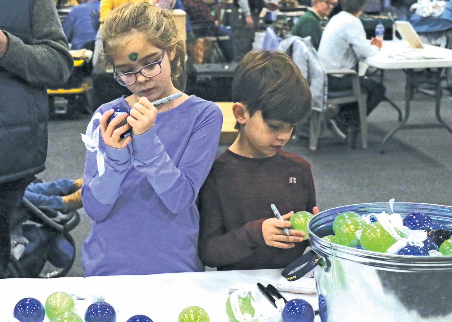 Joey, left, and Axel decorate ornaments, sponsored by Hills Bank.
